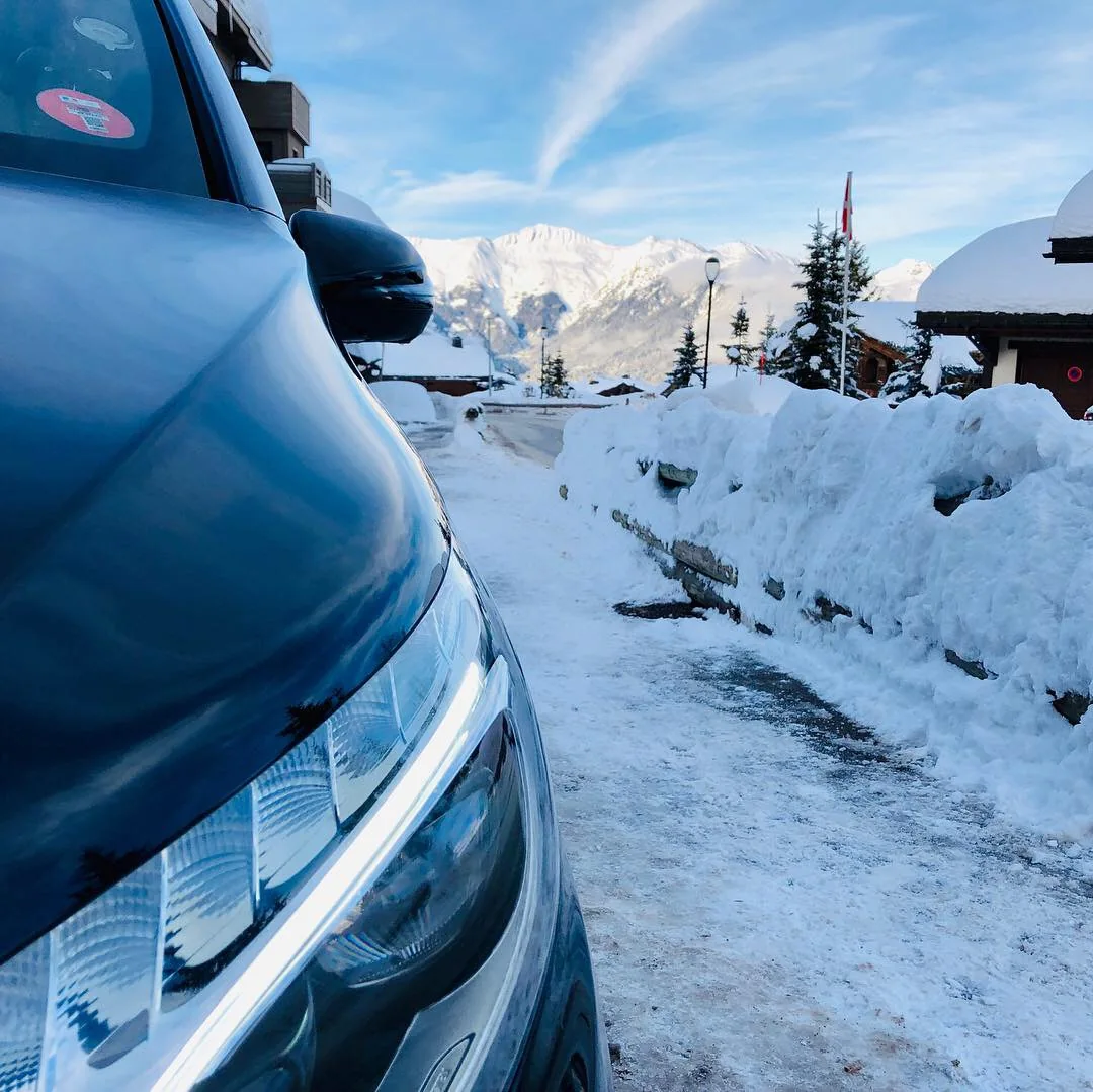 Détail de la Classe V avec un chalet et le paysage enneigé en arrière-plan.