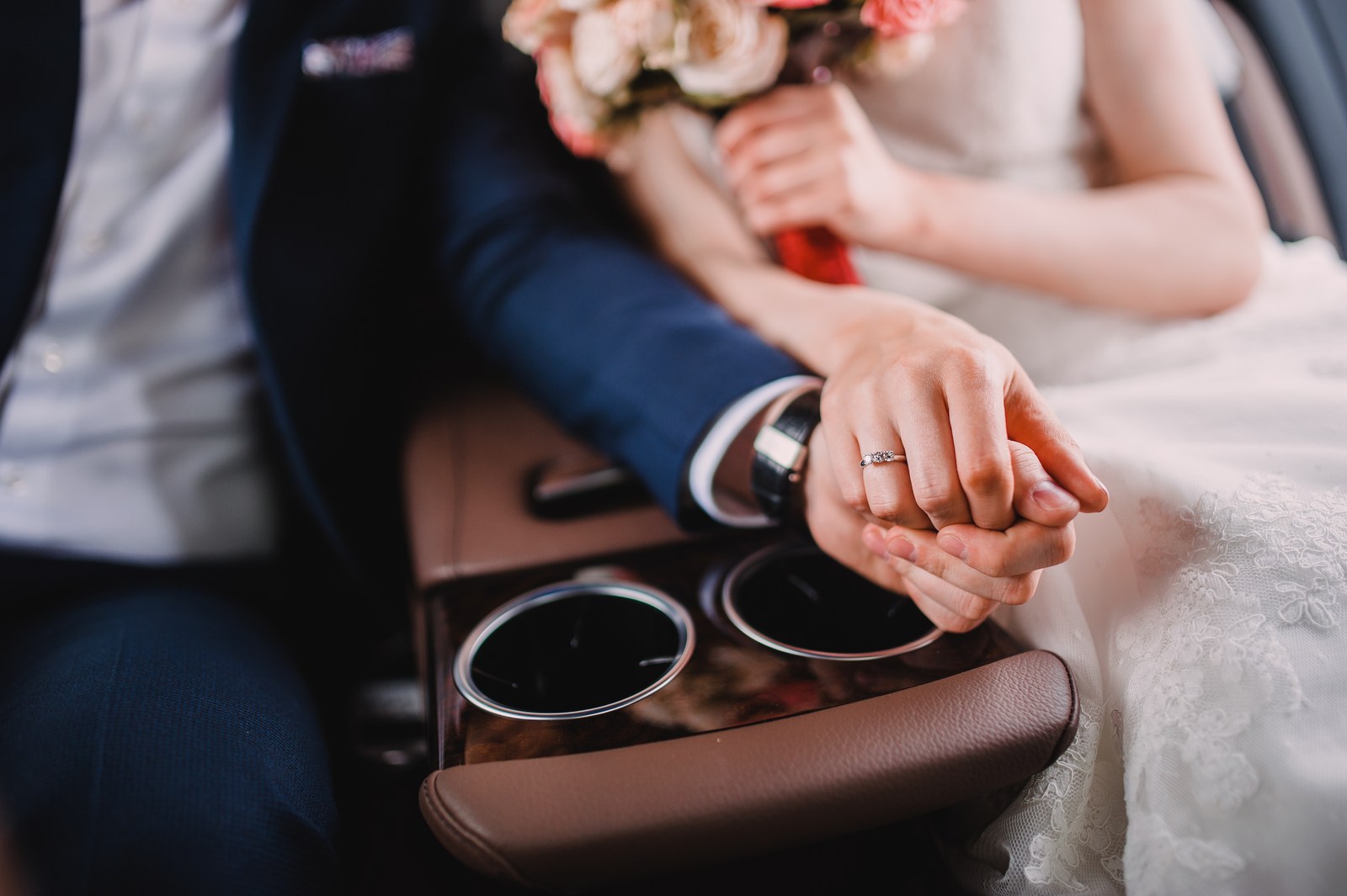 Detail of a wedding couple inside a car