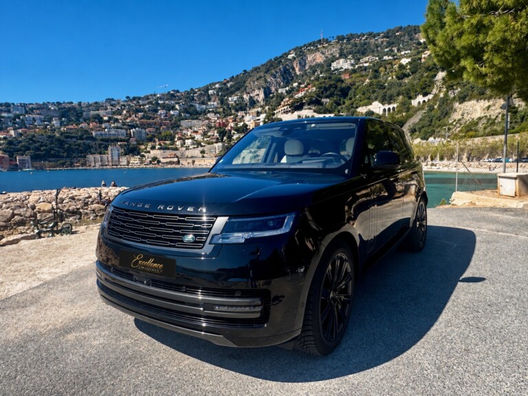 Black Range Rover beside the sea