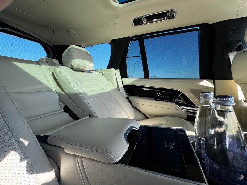 Light-coloured Range Rover interior with rear seats and screen