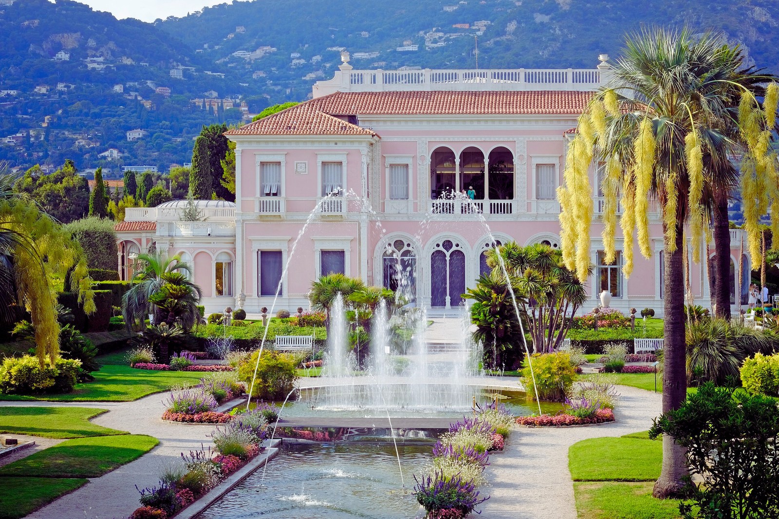 Pink villa and gardens with a fountain on the French Riviera