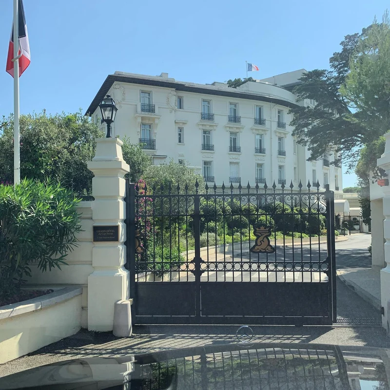 Grand-Hôtel du Cap-Ferrat gates and façade photographed from a Mercedes in 2020.